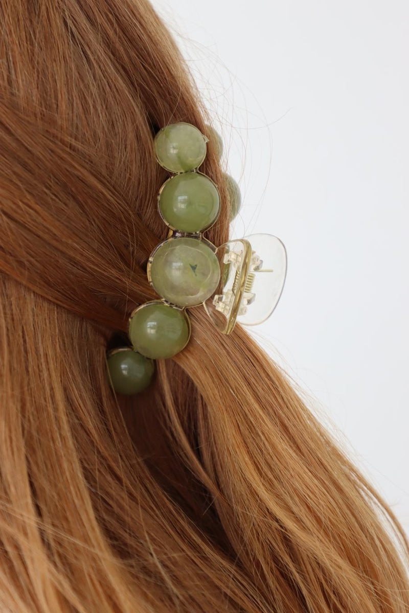 girl wearing green pearl hair clip