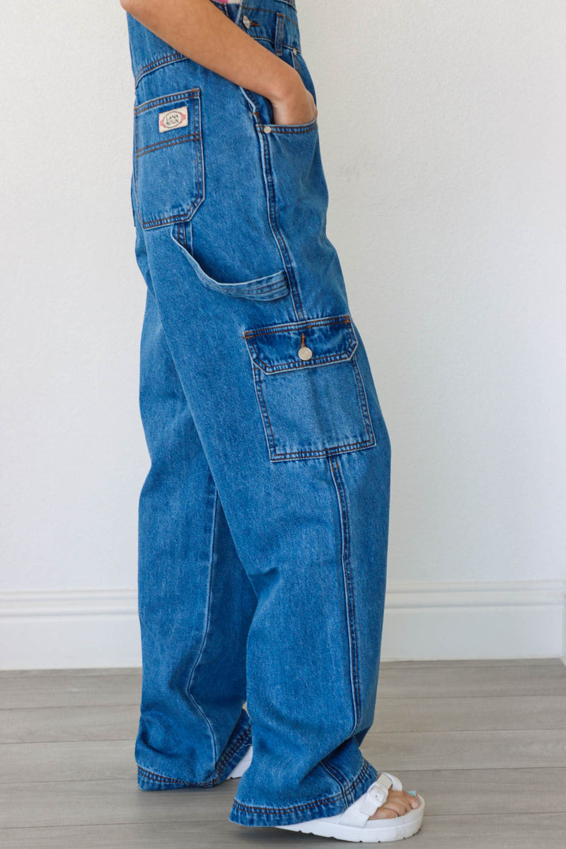 girl wearing blue denim long overalls