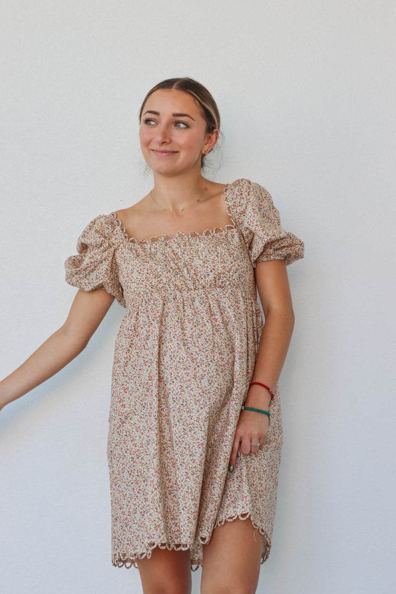 girl wearing tan floral short dress