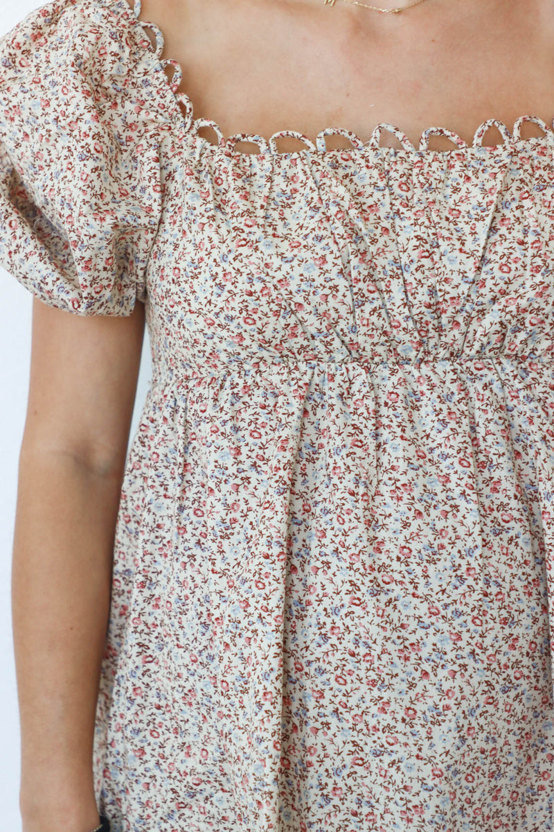 girl wearing tan floral short dress