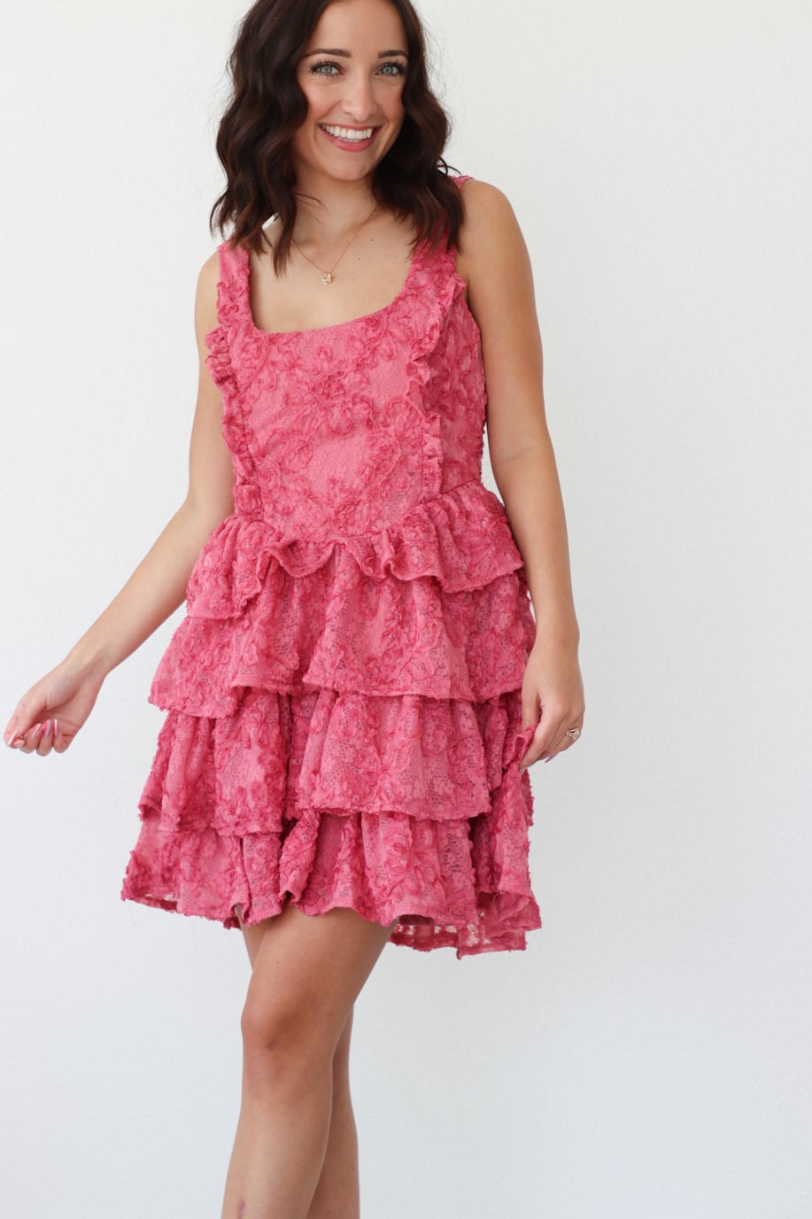 girl wearing short pink ruffle dress