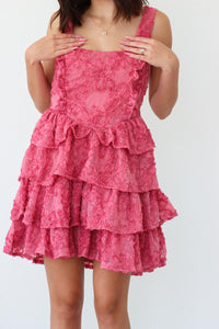 girl wearing short pink ruffle dress