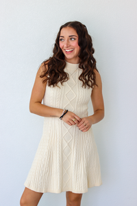 Woman wearing a knit white sweater dress