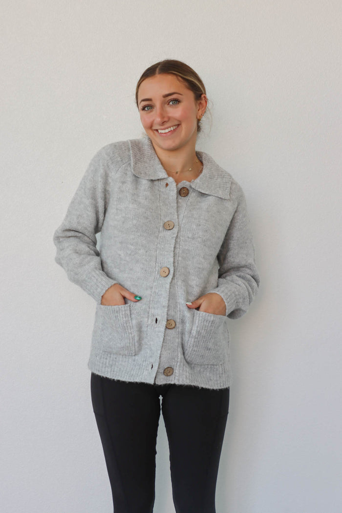 girl wearing light gray cardigan sweater