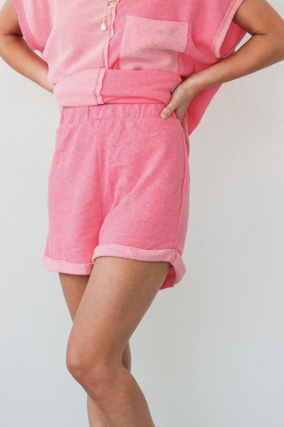 girl wearing pink matching sweat short set