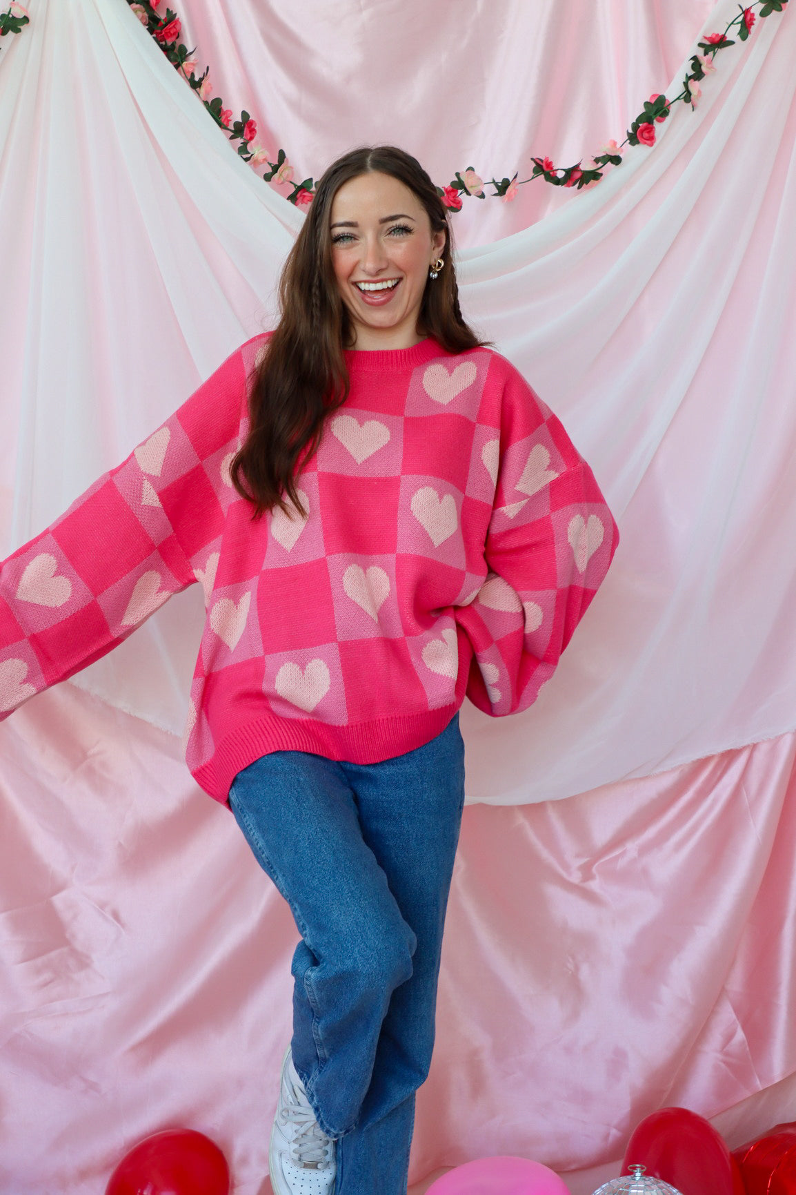 girl wearing pink heart sweater