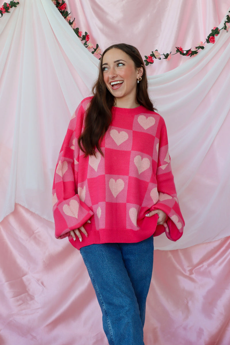 girl wearing pink heart sweater