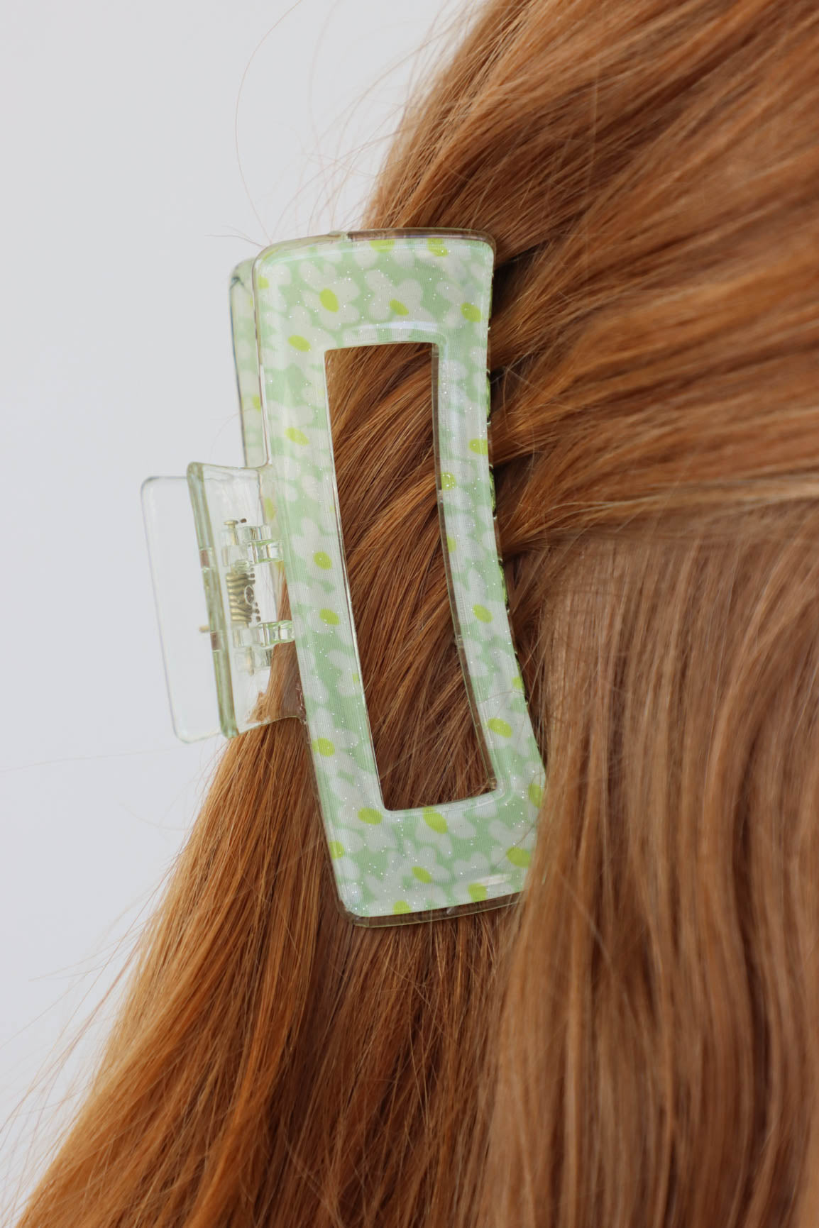 girl wearing green floral hair clip