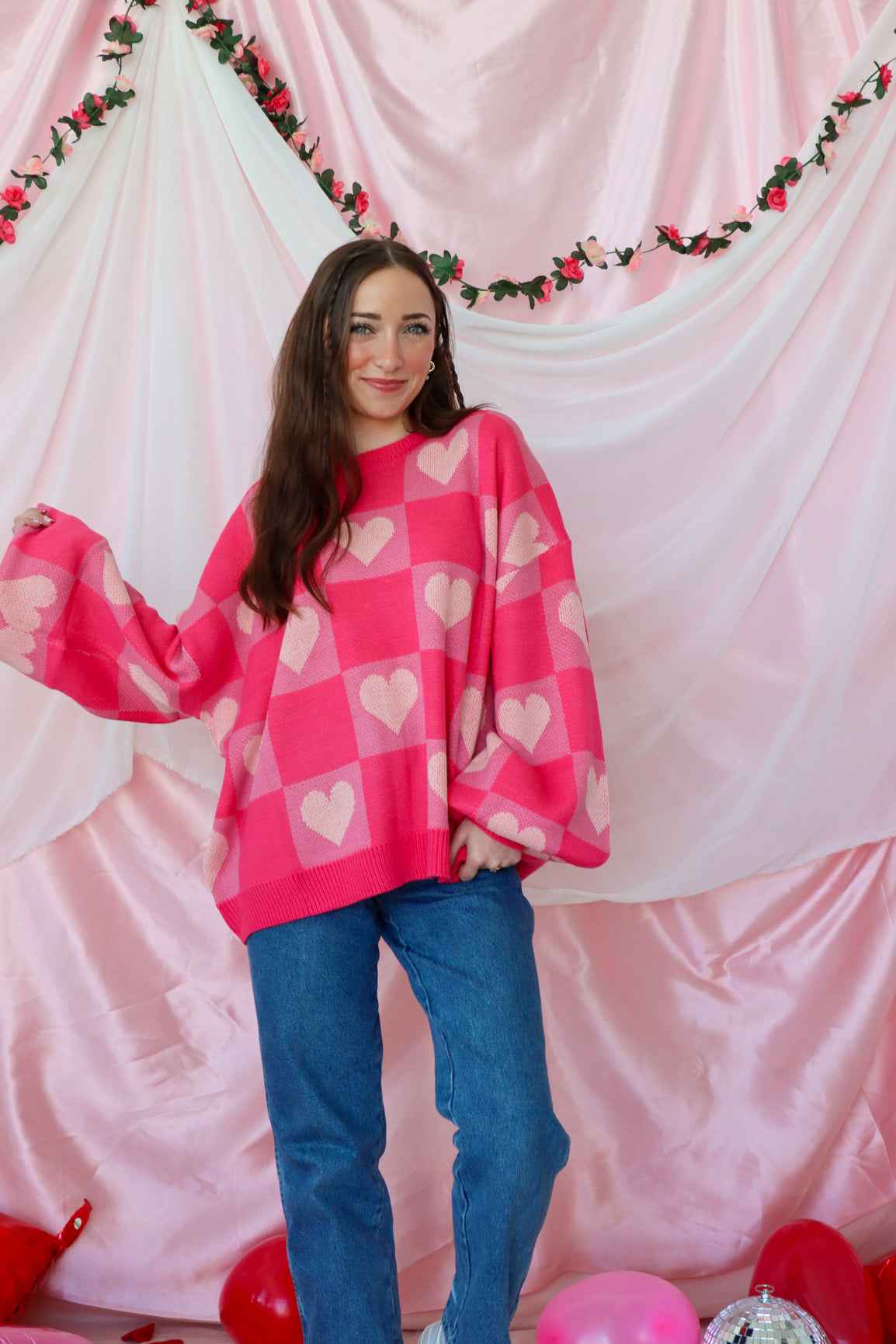 girl wearing pink heart sweater