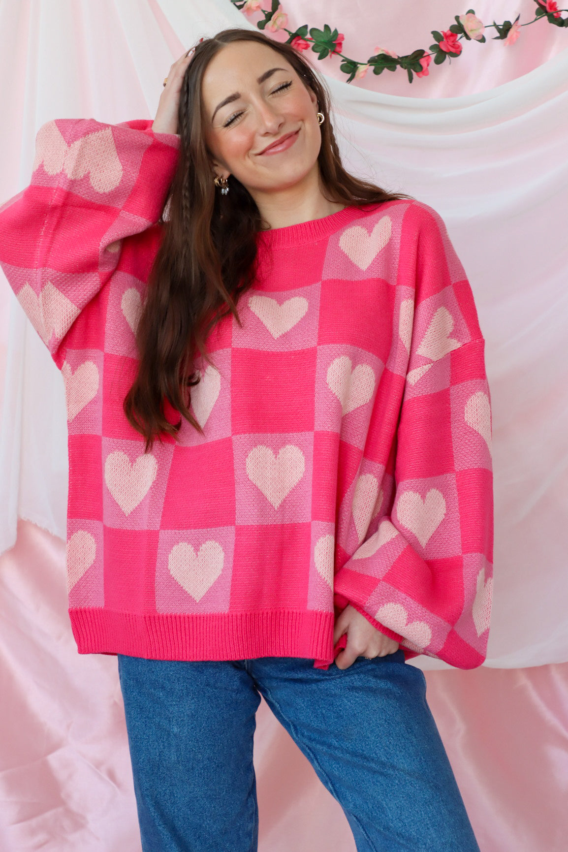 girl wearing pink heart sweater