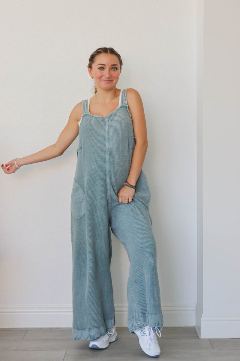 girl wearing blue waffle knit jumpsuit