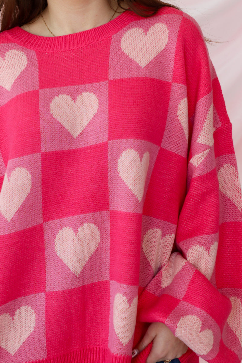 girl wearing pink heart sweater