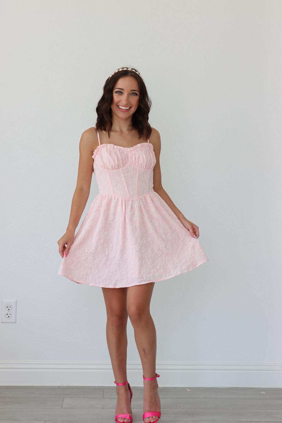 girl wearing short light pink dress