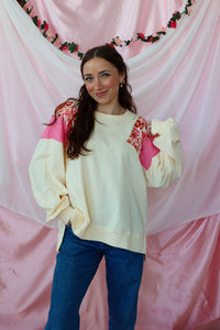 girl wearing a cream paisley top