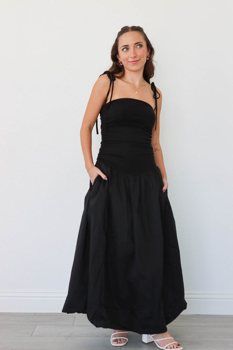 girl wearing long black drop waist dress