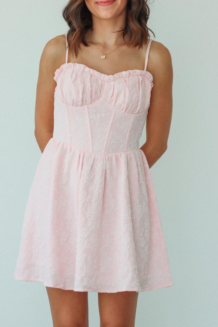 girl wearing short light pink dress