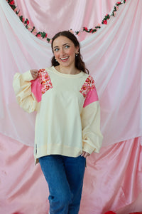 girl wearing a cream paisley top