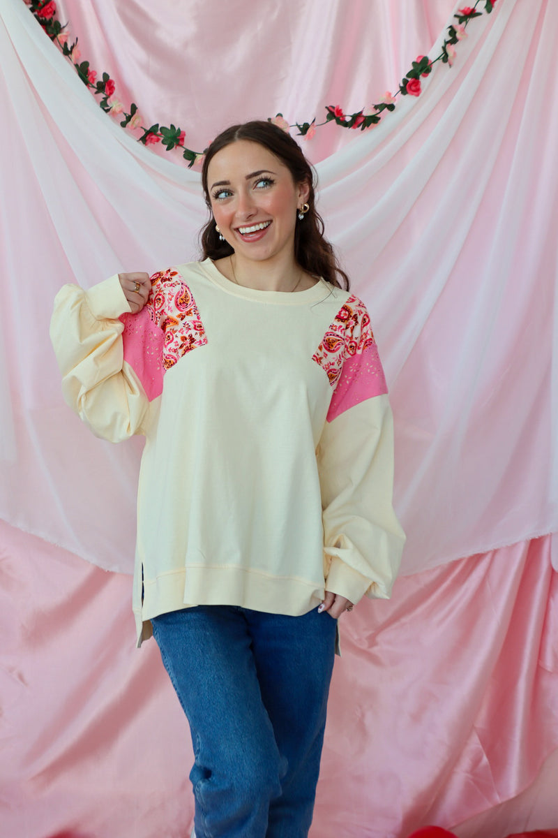 girl wearing a cream paisley top