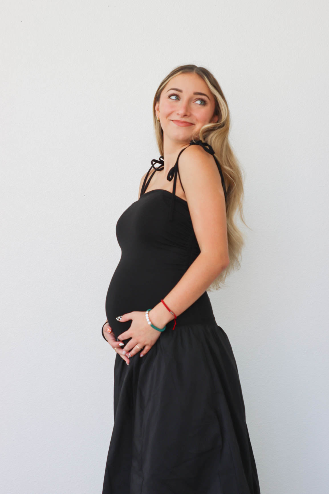 girl wearing long black drop waist dress