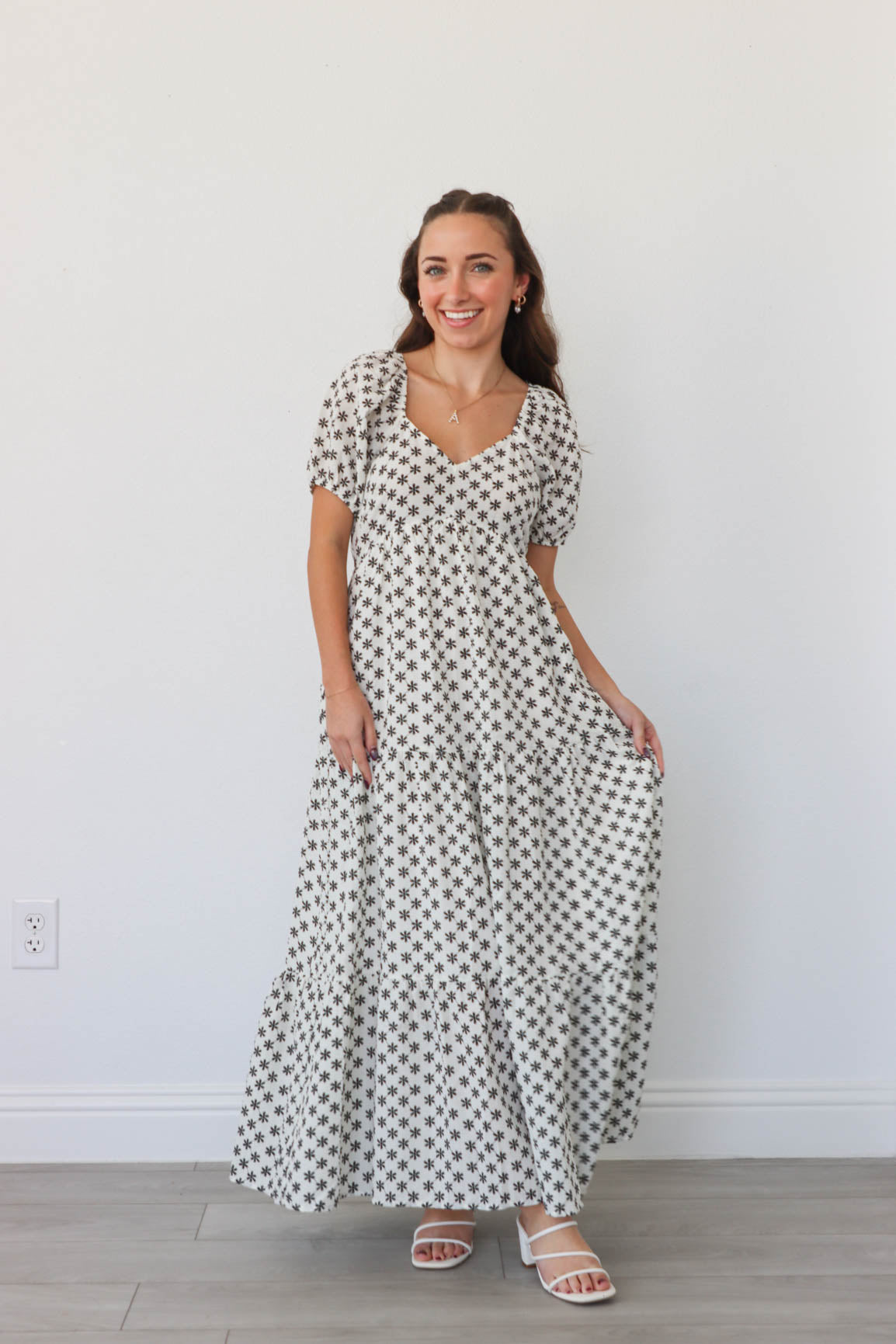 girl wearing white long dress with black flowers