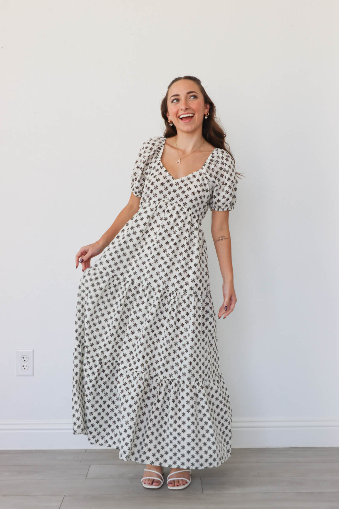 girl wearing white long dress with black flowers