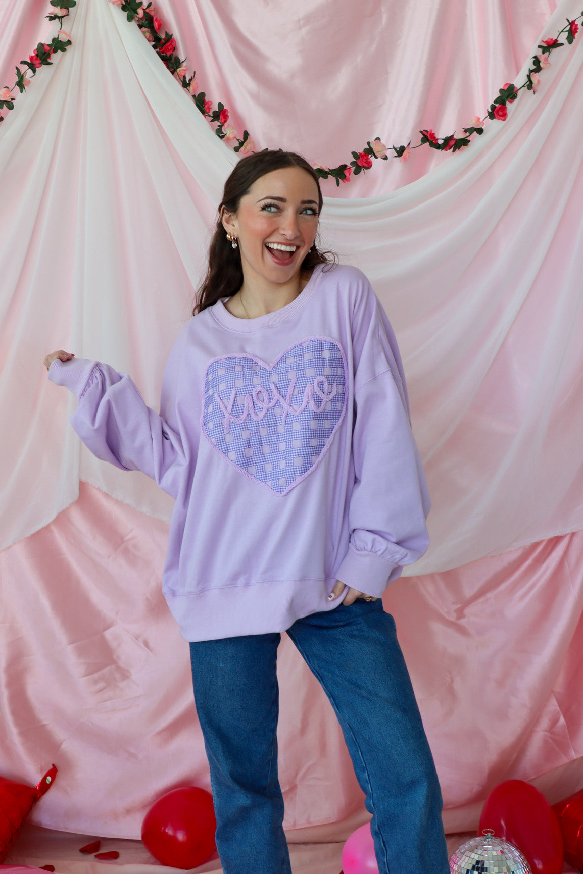 girl wearing light purple "xoxo" top