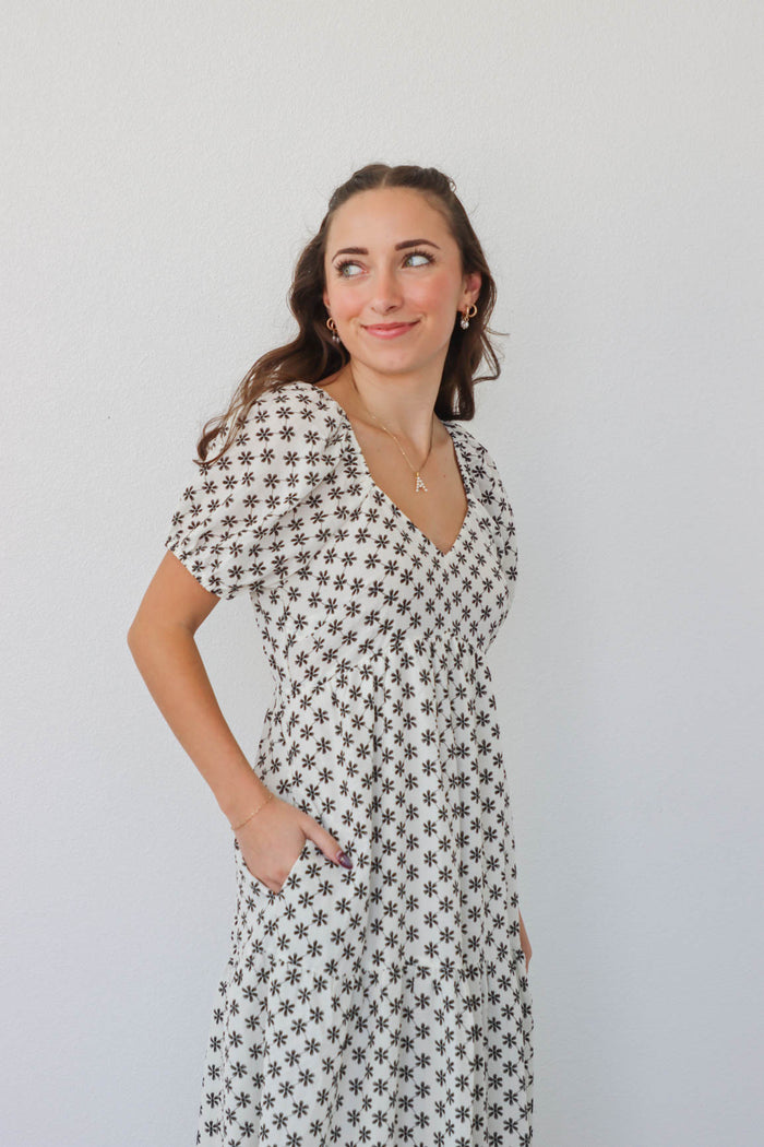 girl wearing white long dress with black flowers