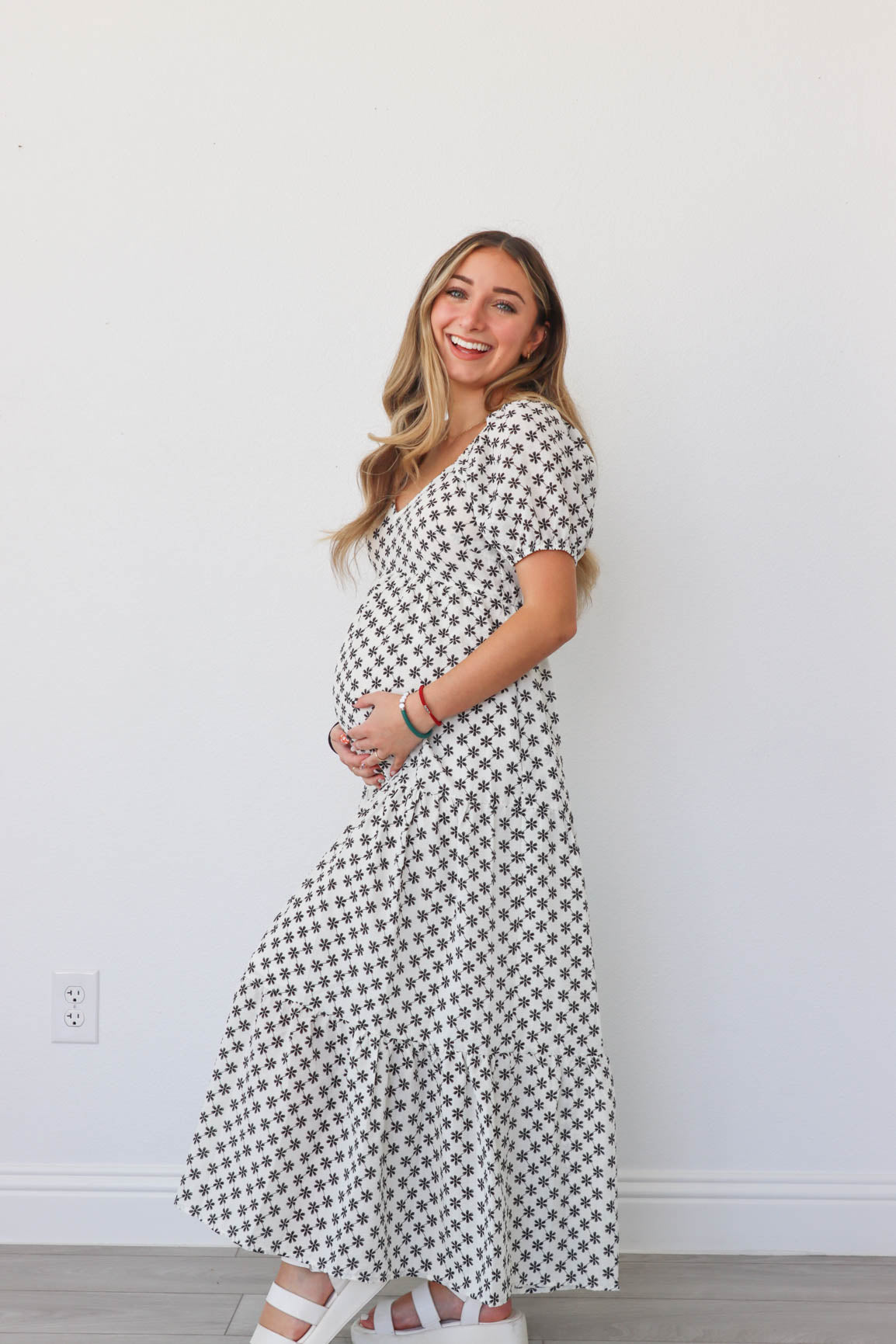 girl wearing white long dress with black flowers