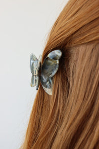 girl wearing brown butterfly hair clip