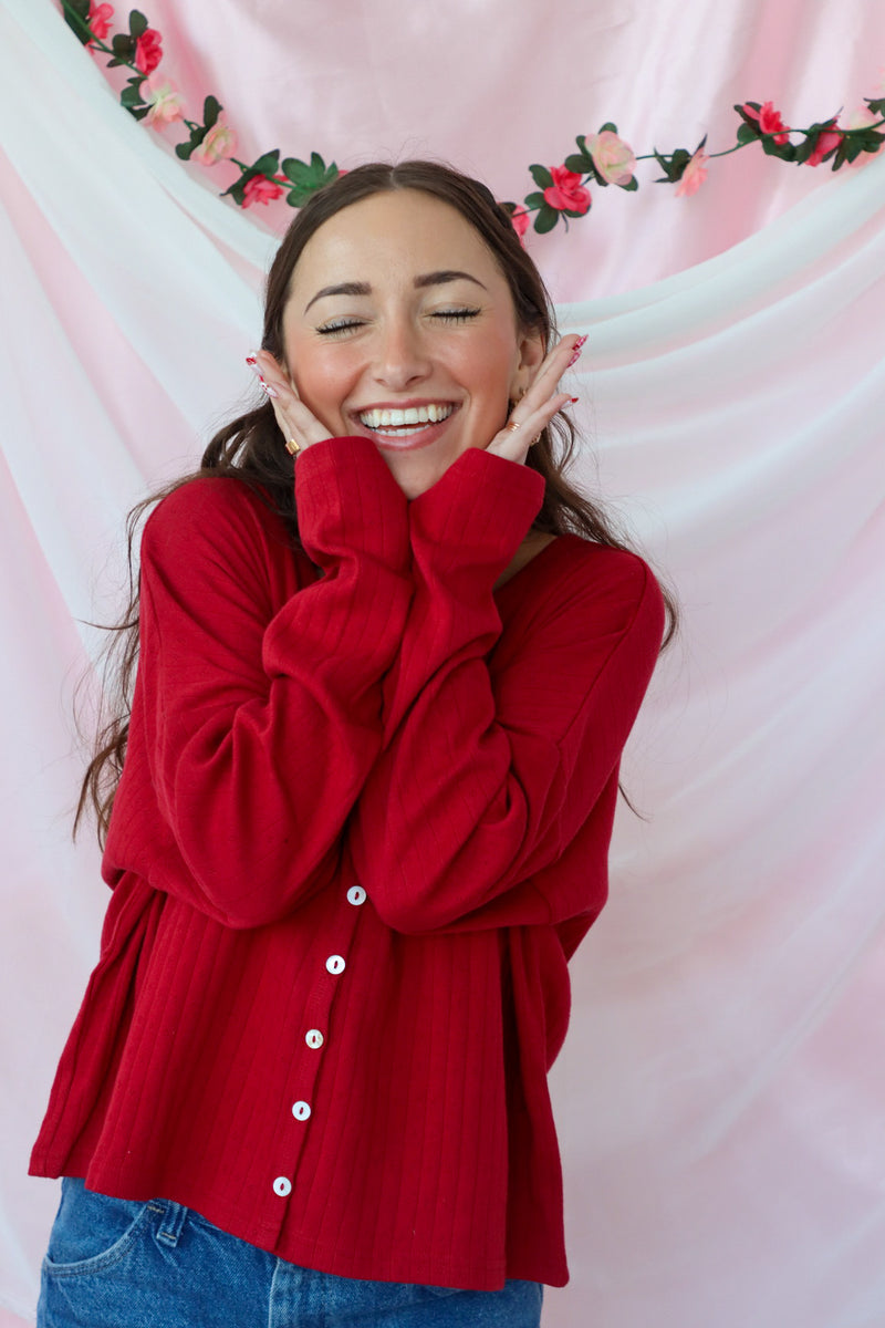 girl wearing red button down top