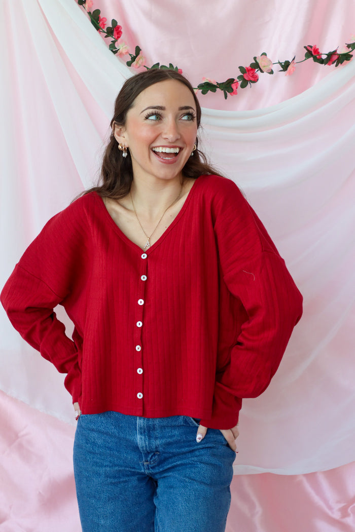 girl wearing red button down top