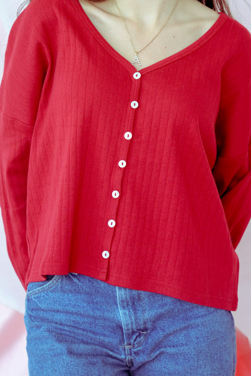 girl wearing red button down top