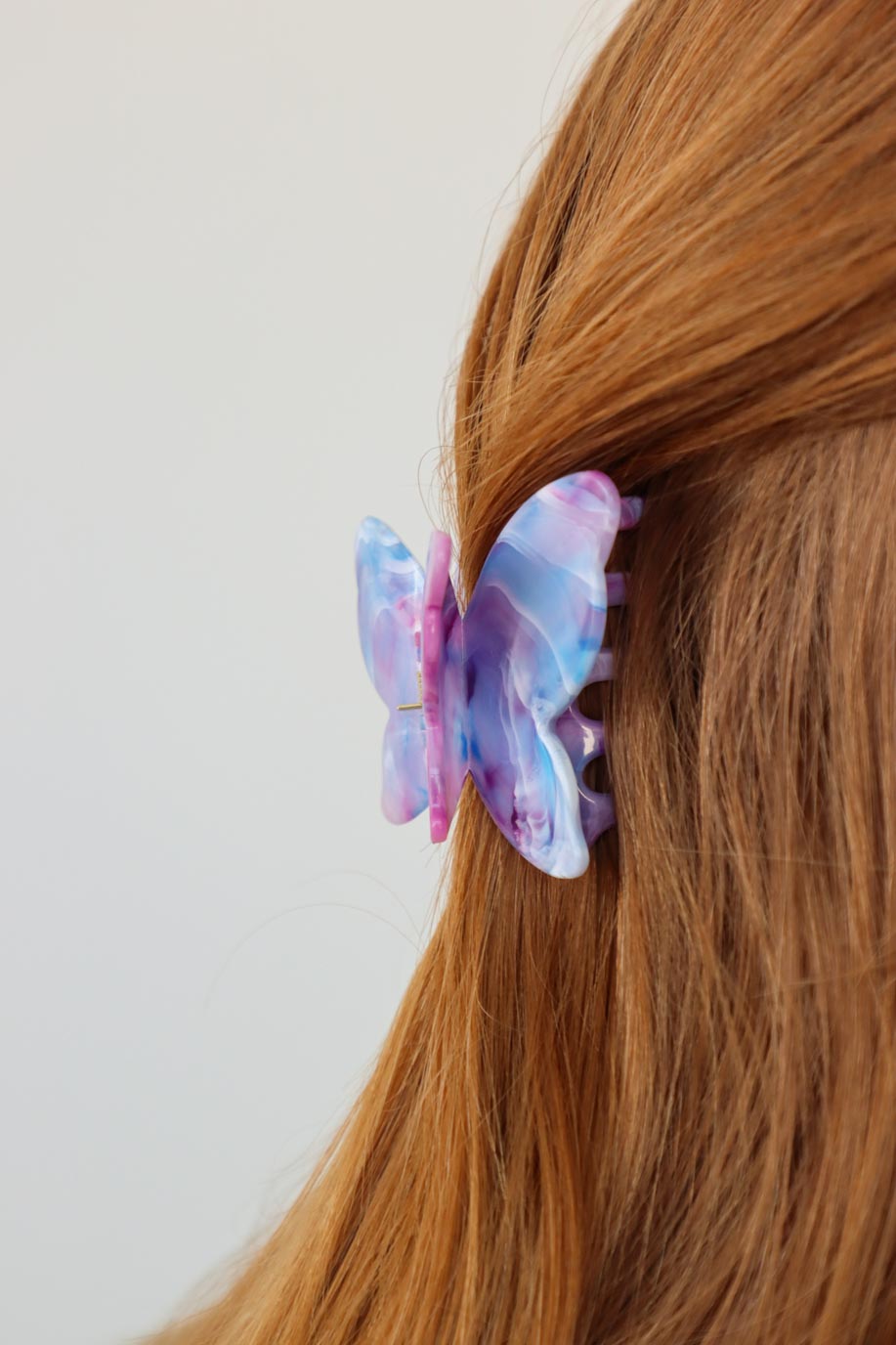 girl wearing purple butterfly hair clip