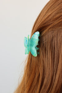 girl wearing blue butterfly hair clip