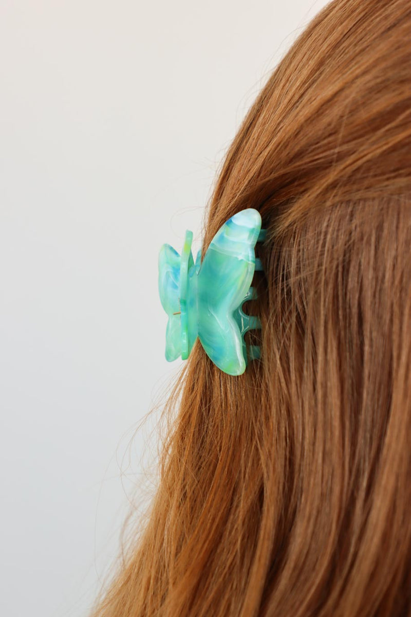 girl wearing blue butterfly hair clip