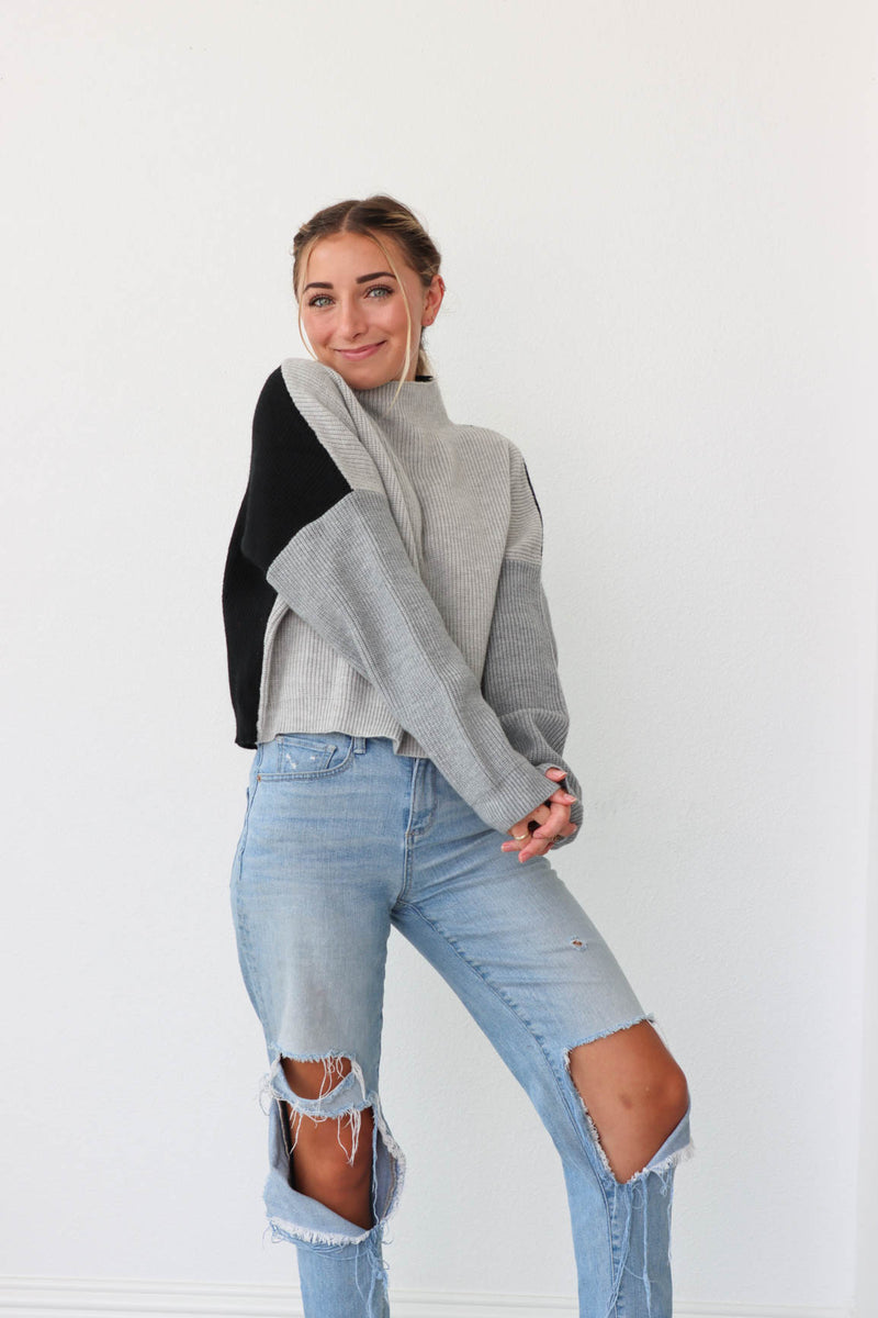 girl wearing gray and black colorblocked sweater