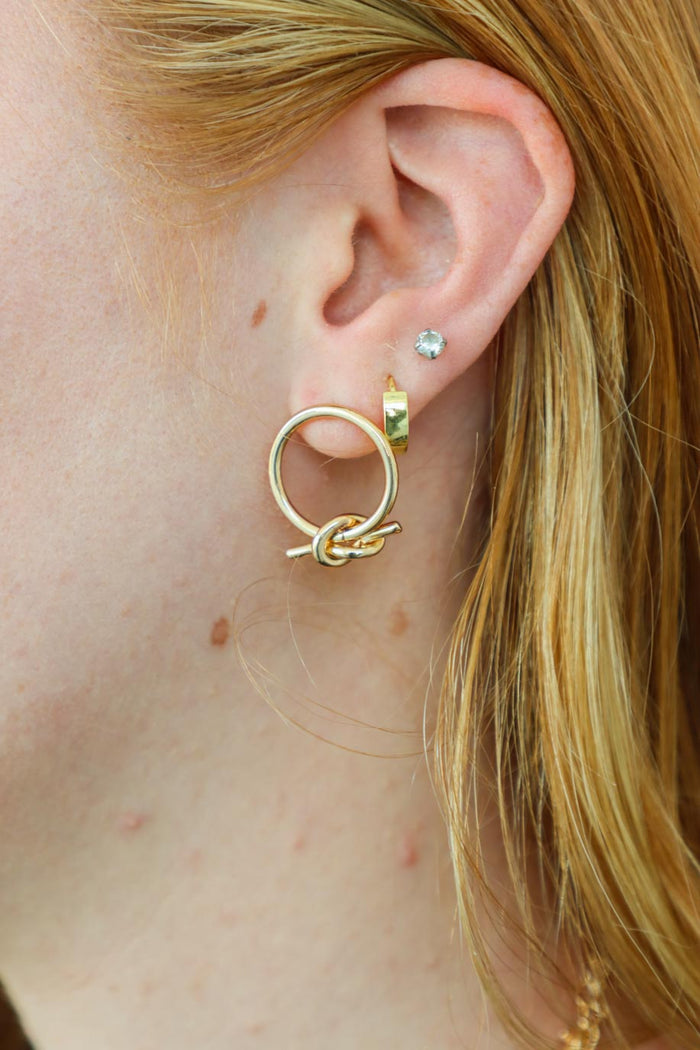 gold earrings with knot detailing