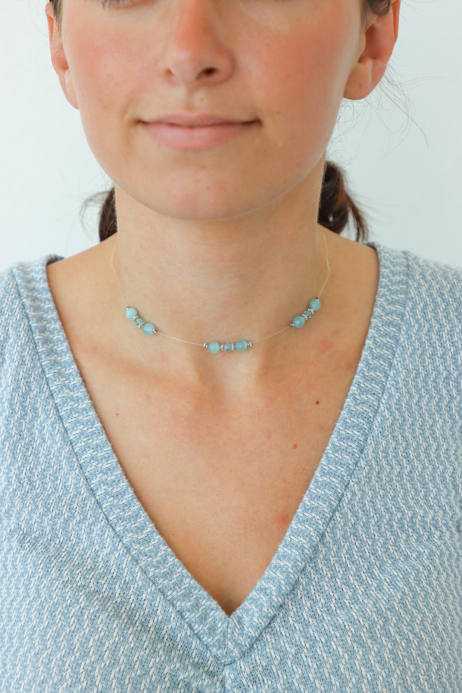 girl wearing blue beaded choker necklace