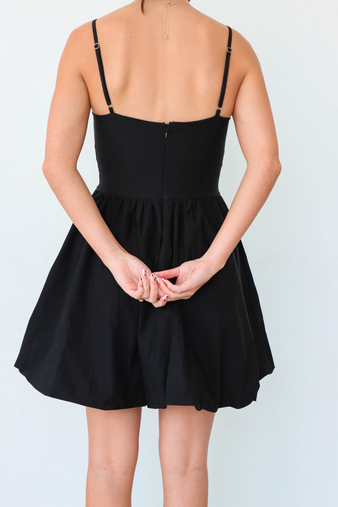 back zipper detailing on short black dress