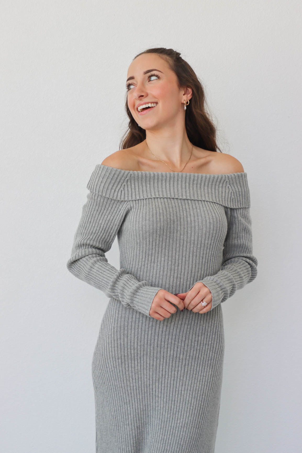 girl wearing long gray knit off the shoulder dress