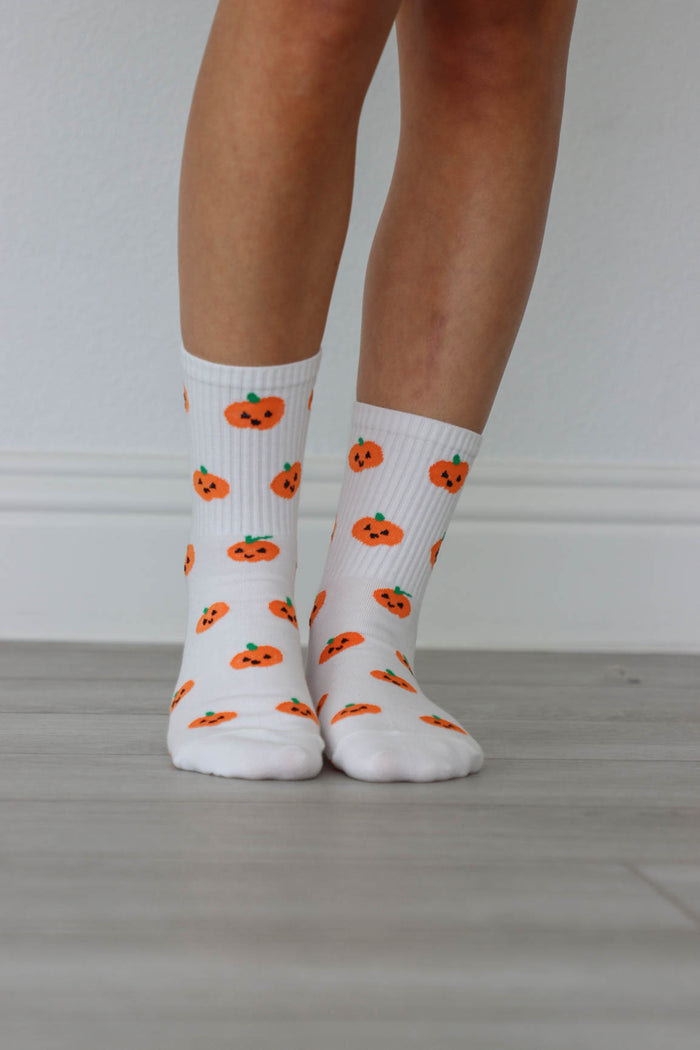 white crew socks with orange pumpkin graphics