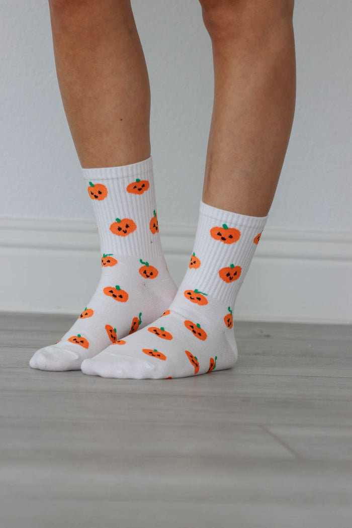 white crew socks with orange pumpkin graphics