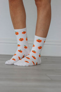 white crew socks with orange pumpkin graphics