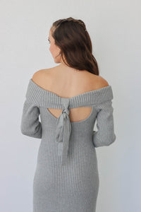 girl wearing long gray knit off the shoulder dress