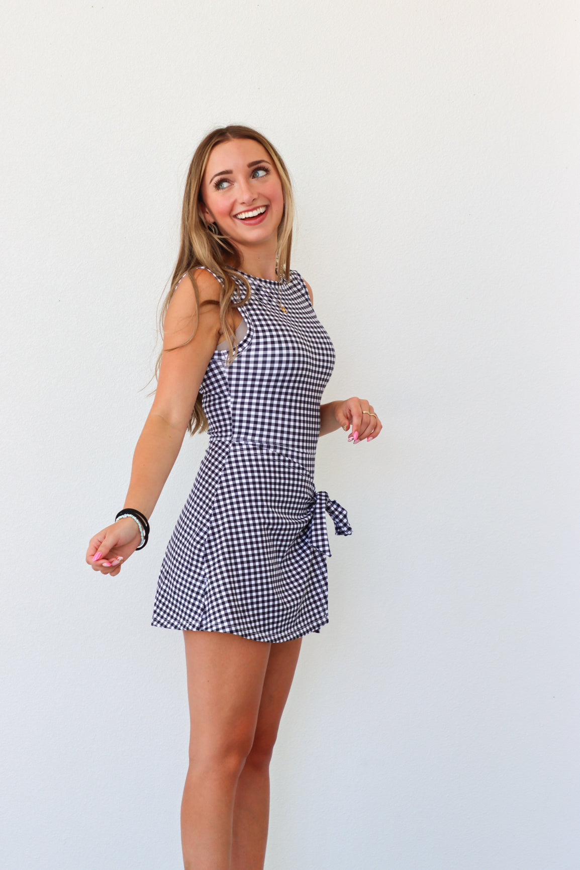 Woman wearing a checkered dress against a white background