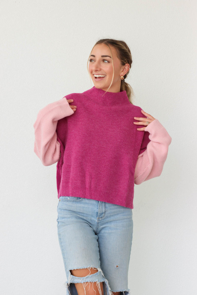 girl wearing purple and pink colorblocked sweater
