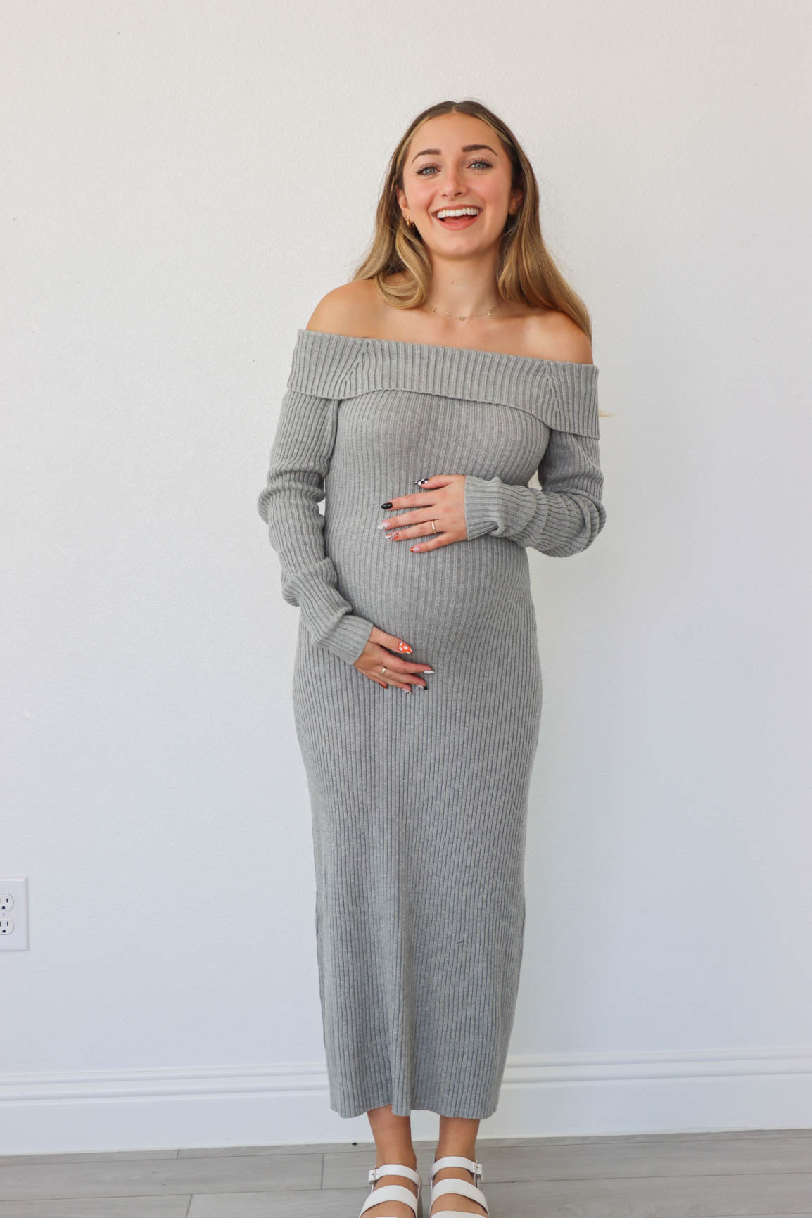 girl wearing long gray knit off the shoulder dress