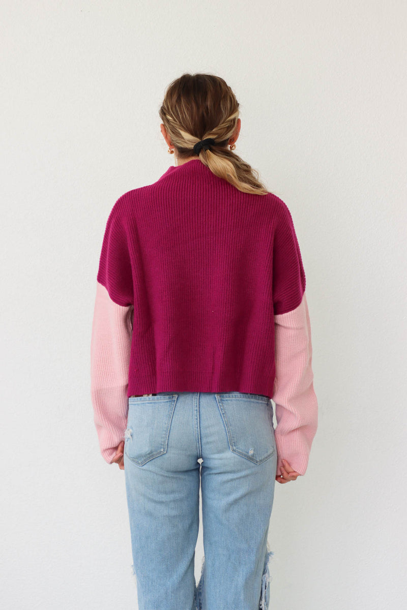 girl wearing purple and pink colorblocked sweater