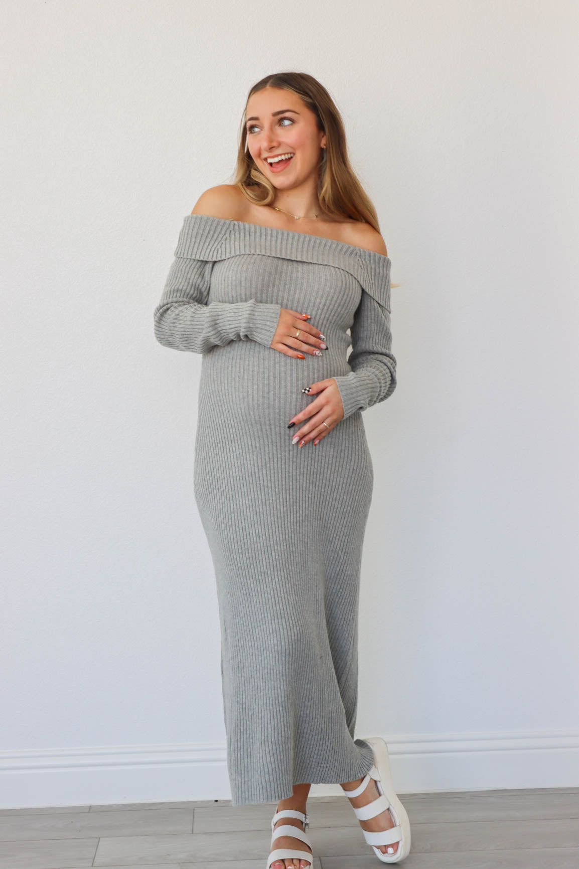 girl wearing long gray knit off the shoulder dress