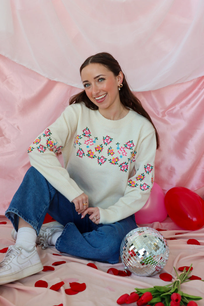 girl wearing cream floral sweater